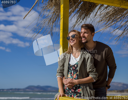 Image of Couple chating and having fun at beach bar