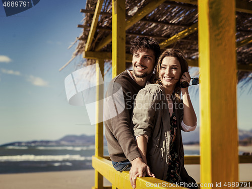 Image of Couple chating and having fun at beach bar