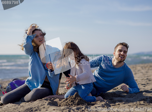 Image of Young family enjoying vecation during autumn day