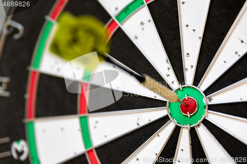 Image of a typical darts game with dart in the bullseye