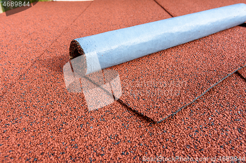 Image of The roof is finished with red bituminous tiles