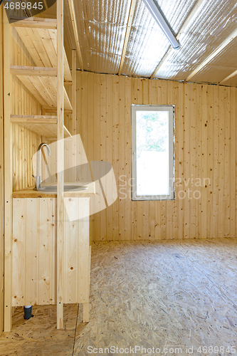 Image of Installed stylish author\'s homemade kitchen in the interior of a small country house