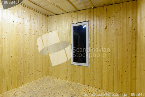 Image of Walls finished with wooden clapboard in the interior of a country empty house