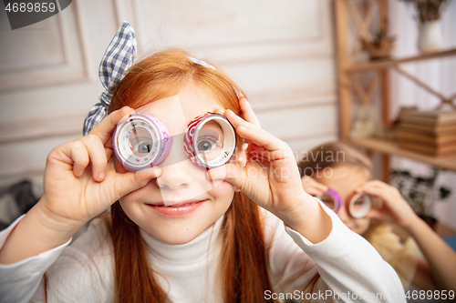 Image of Two little children, girls together in creativity of the house. Happy kids make handmade toys for games or New Year celebration