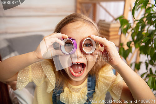 Image of Little girl in creativity of the house. Happy kid makes handmade toys for games or New Year celebration