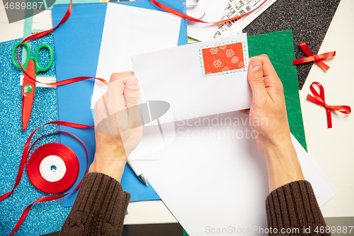 Image of Man making greeting card for New Year and Christmas 2021 for friends or family, scrap booking, DIY