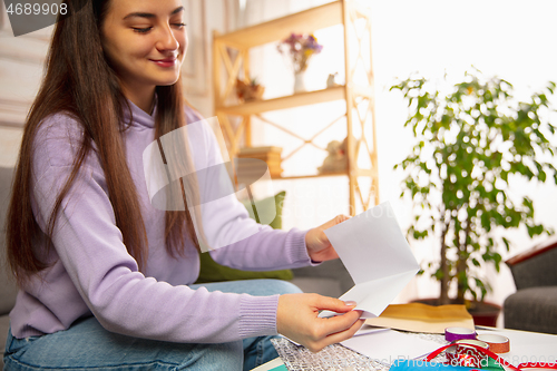 Image of Woman writing letter, greeting card for New Year and Christmas 2021 for friends or family
