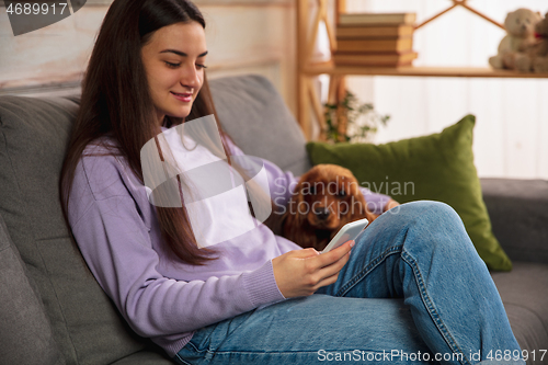 Image of Woman reading message, greetings for New Year and Christmas 2021 from friends or family with her cellphone