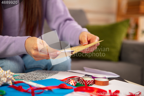 Image of Woman making greeting card for New Year and Christmas 2021 for friends or family, scrap booking, DIY