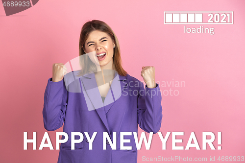 Image of Caucasian young woman\'s portrait isolated on pink studio background, celebrating New 2021 Year and Christmas