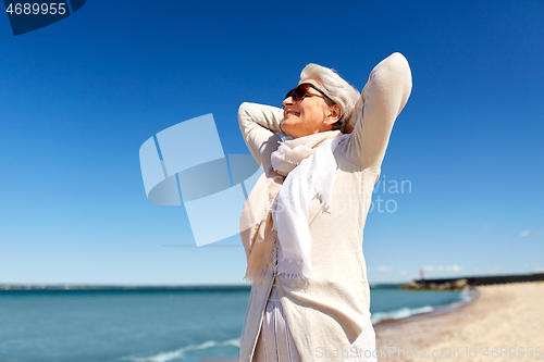 Image of portrait of senior woman in sunglasses on beach