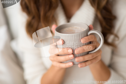 Image of close up of happy woman with cup of coffee at home