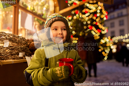 Image of happy boy with cup of tea at christmas market