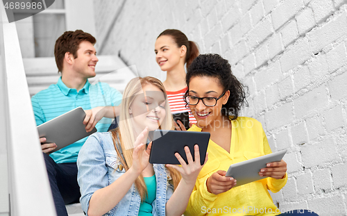 Image of high school students with tablet computers