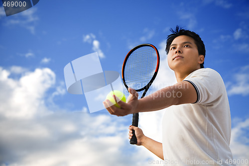 Image of Asian male playing tennis