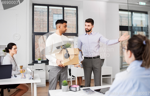 Image of executive seeing off sad fired male office worker