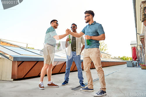 Image of happy male friends with beer meeting on rooftop