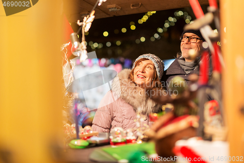 Image of senior couple at christmas market souvenir shop