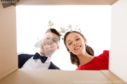 Image of happy couple opening christmas gift box