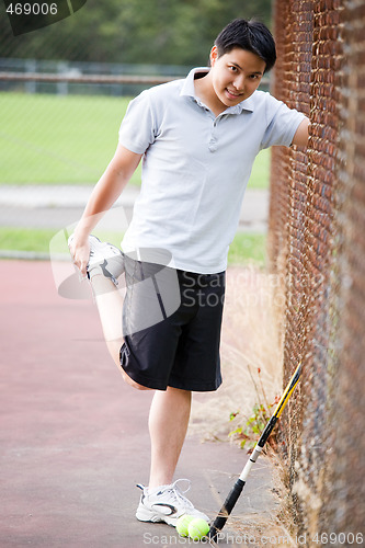 Image of Young asian male tennis player