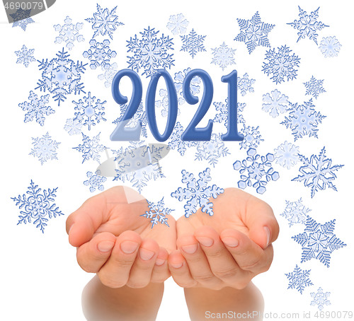 Image of Flying snowflakes from woman’s cupped hands with 2021 text