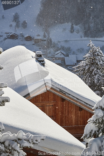 Image of Winter mountain village, roof and chimney covered with snow