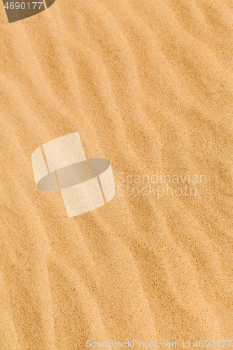 Image of Yellow desert sand with diagonal wave patern.