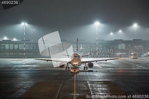 Image of Airliner at an airport at night