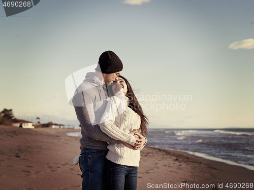 Image of Loving young couple on a beach at autumn sunny day