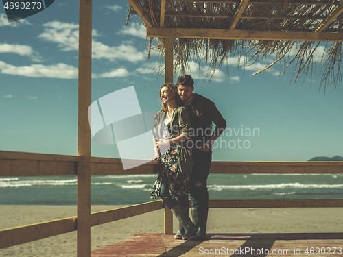 Image of Couple chating and having fun at beach bar