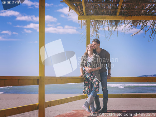 Image of Couple chating and having fun at beach bar