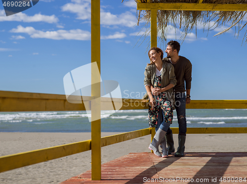 Image of Couple chating and having fun at beach bar