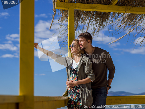 Image of Couple chating and having fun at beach bar