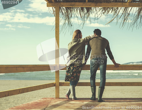 Image of Couple chating and having fun at beach bar