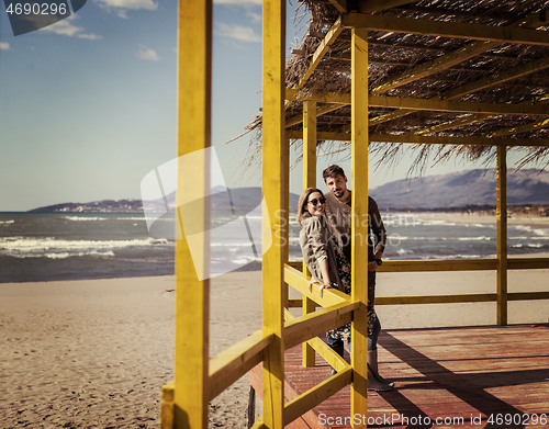 Image of Couple chating and having fun at beach bar