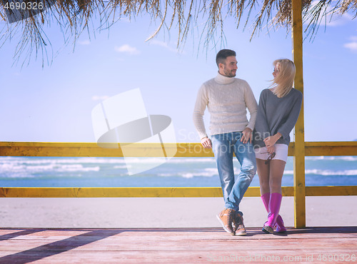 Image of Couple chating and having fun at beach bar