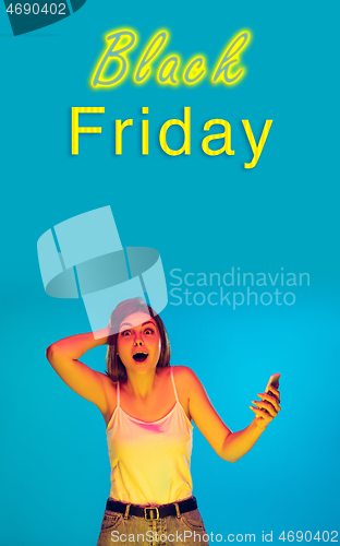 Image of Beautiful woman inviting for shopping in black friday, sales concept. Vertical flyer, blue background