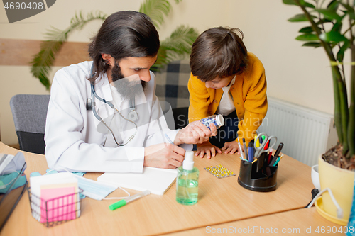 Image of Paediatrician doctor examining a child in comfortabe medical office