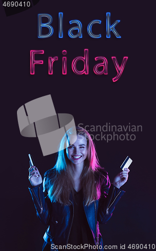 Image of Beautiful woman inviting for shopping in black friday, sales concept. Vertical flyer, neoned style, dark background