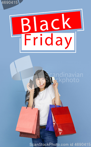 Image of Beautiful woman inviting for shopping in black friday, sales concept. Vertical flyer, blue background