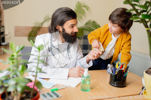 Image of Paediatrician doctor examining a child in comfortabe medical office