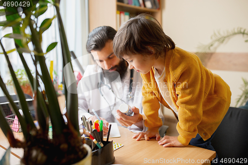 Image of Paediatrician doctor examining a child in comfortabe medical office