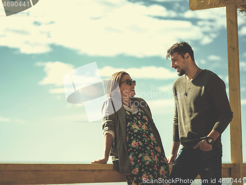 Image of Couple chating and having fun at beach bar