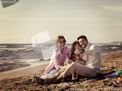 Image of Young family enjoying vecation during autumn day