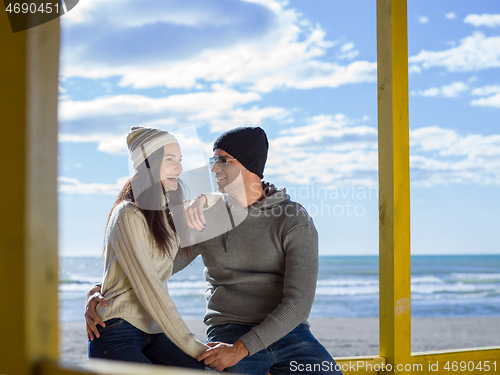 Image of Couple chating and having fun at beach bar