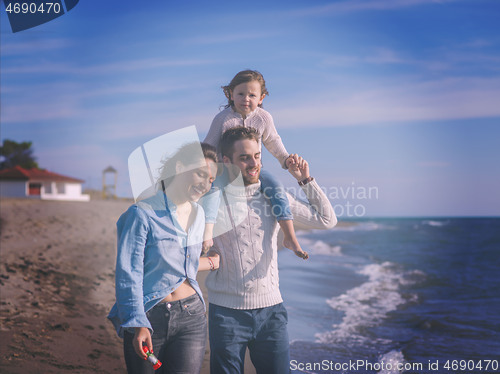 Image of Young family enjoying vecation during autumn day