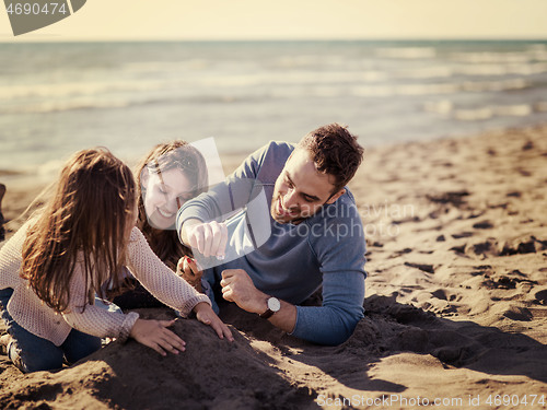 Image of Young family enjoying vecation during autumn day