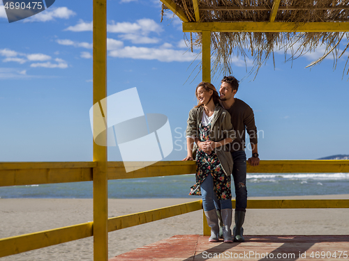 Image of Couple chating and having fun at beach bar