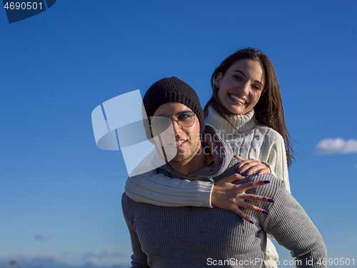 Image of couple having fun at beach during autumn