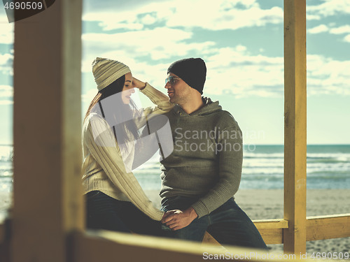 Image of Couple chating and having fun at beach bar